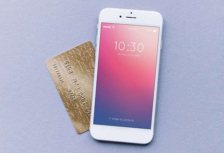 a white iphone and a gold credit card