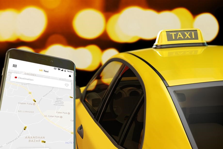 a mobile with a taxi booking app and a taxi besides it