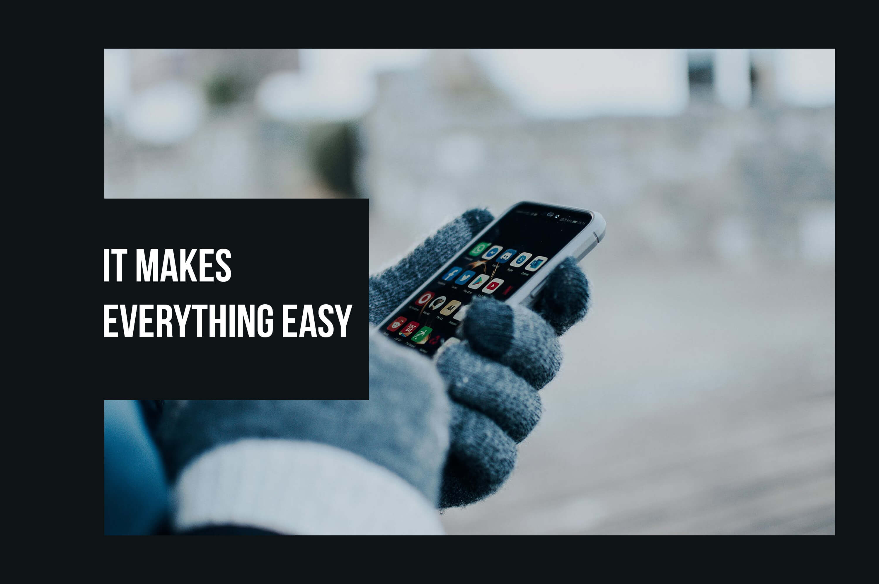 a man holding a smartphone by wearing gloves